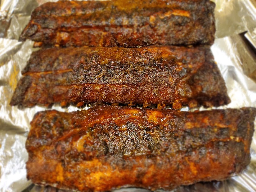 Dry-rubbed baby backs smoked with red oak and pecan wood