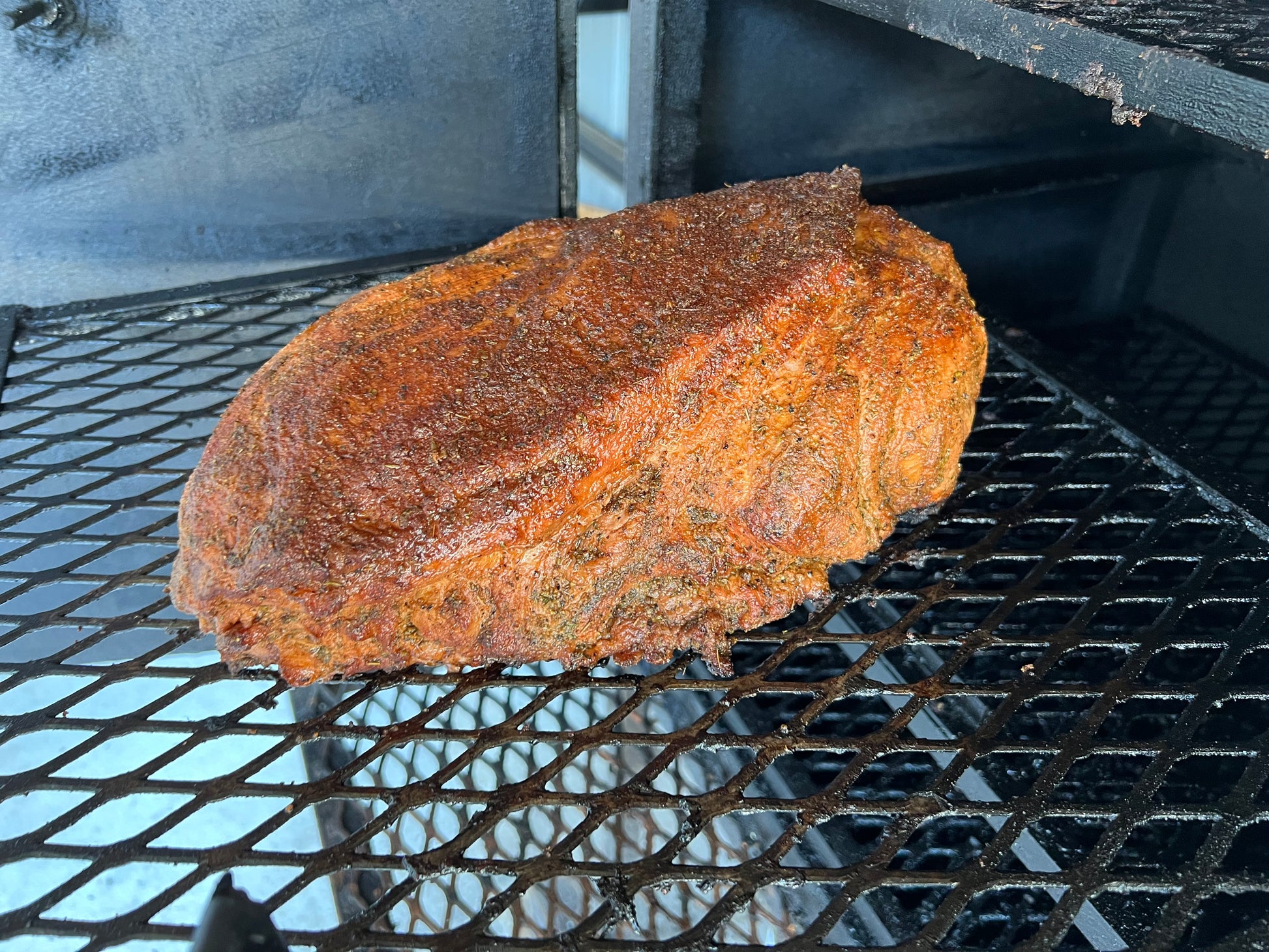 Tender smoked pulled pork servd on buttered texas toast with a side with a side of cole slaw on the side.